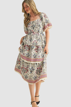 Woman wearing a vintage floral boho midi dress with layered skirt, soft flowy fabric, and elegant summer style outfit