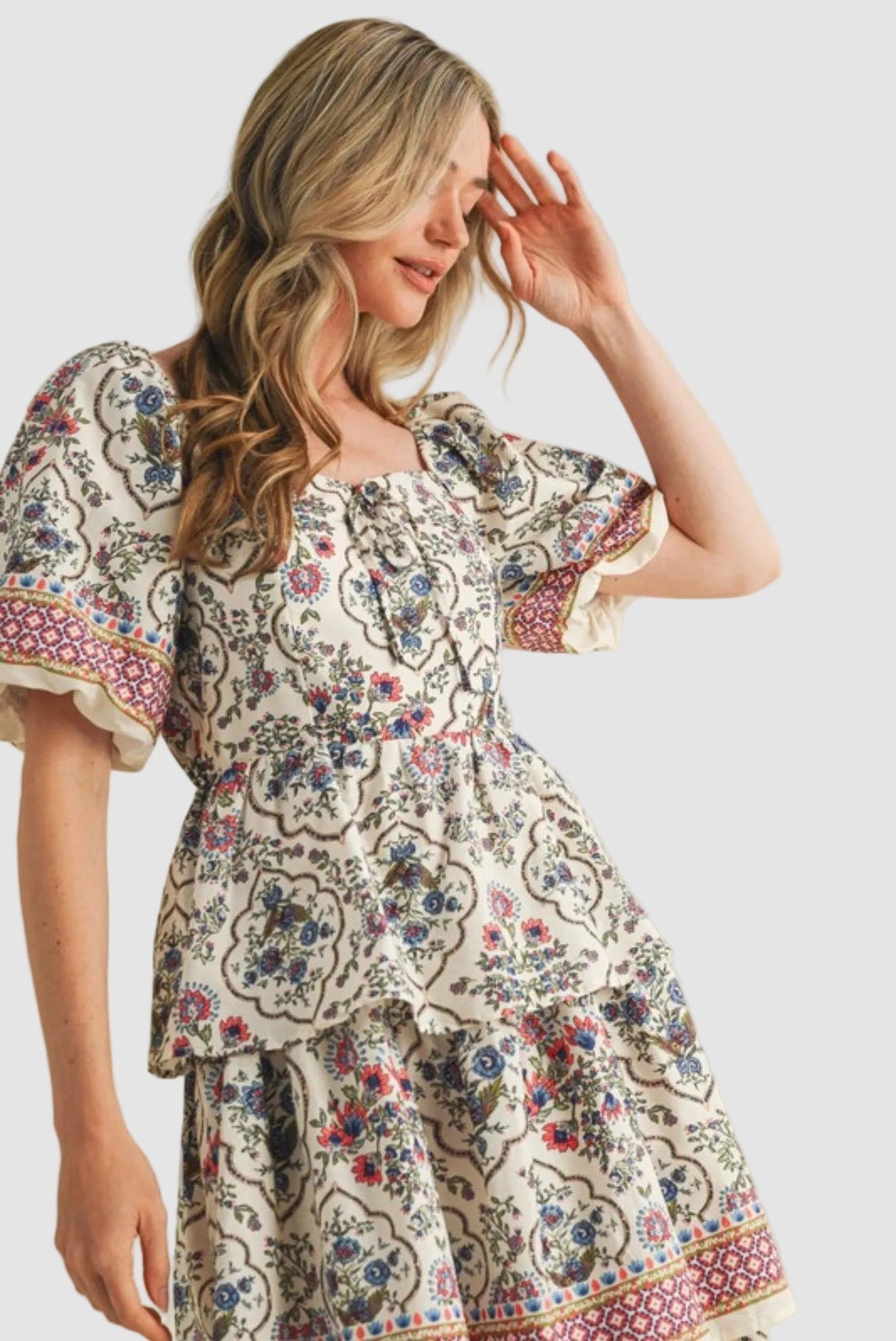 Woman wearing a vintage floral boho midi dress with layered skirt, soft flowy fabric, and elegant summer style outfit